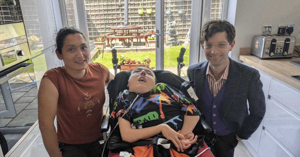 Dr. Sarah Fortais and Cameron from UCL smiling with Joseph Kendrick in the centre.